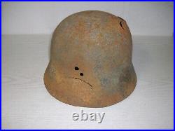 German steel helmet M40 from WW2 Ardenne Forest battle damaged