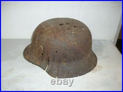 German steel helmet M42 from WW2 Ardenne Forest with shrapnel damage